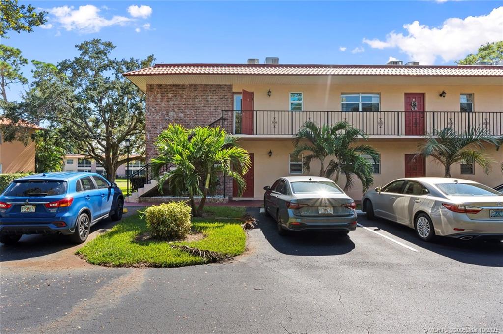 1913 Southwest Palm City Road, Unit 7F Stuart, FL 34994 - Photo 2 of 28 a couple of cars parked in front of a house