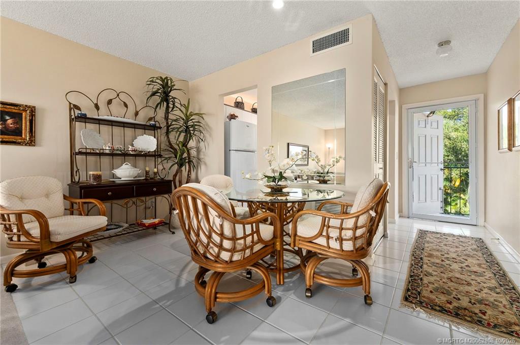1913 Southwest Palm City Road, Unit 7F Stuart, FL 34994 - Photo 7 of 28 a dining room with furniture and window
