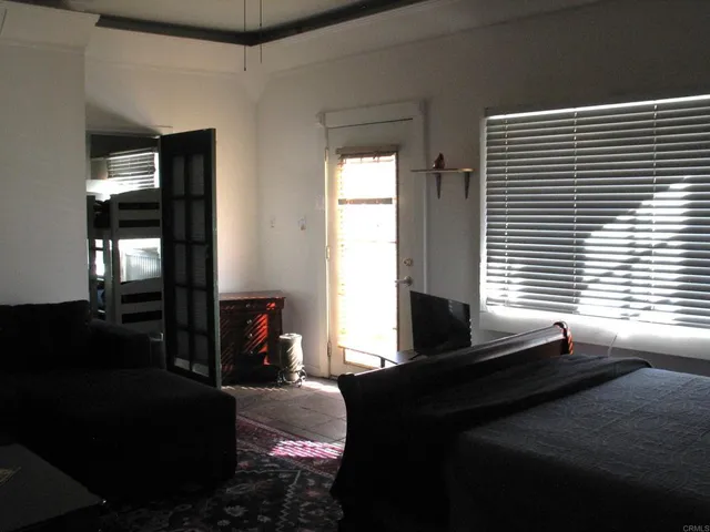 a bedroom with a bed and window