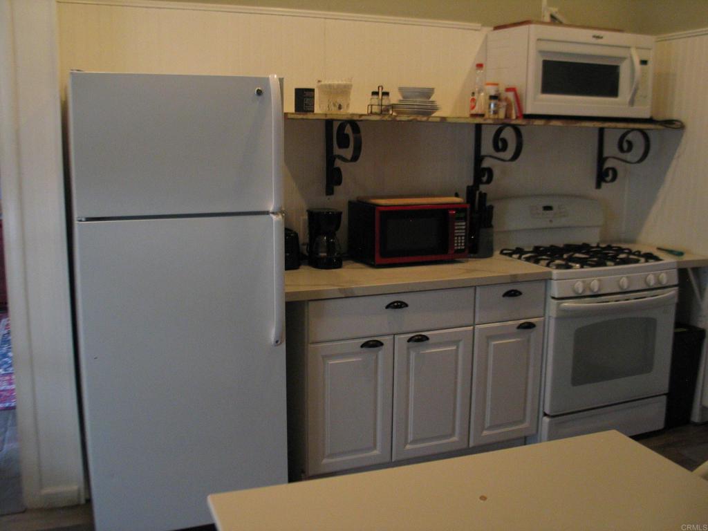2102 3rd Street Julian, CA 92036 - Photo 9 of 20 a kitchen with stainless steel appliances a refrigerator stove and microwave