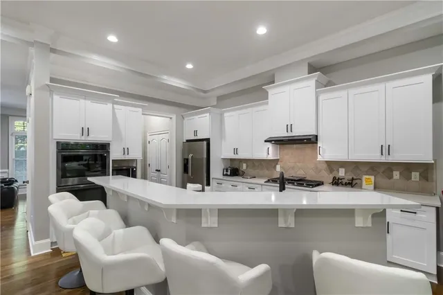 a kitchen with stainless steel appliances granite countertop a sink and cabinets