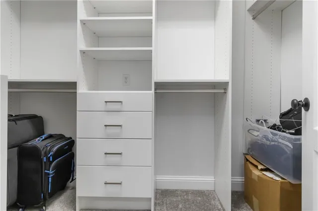 a room with a closet and wooden cabinets
