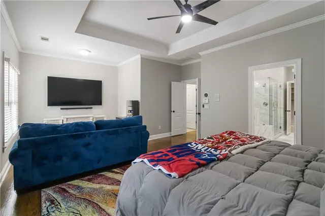 a bedroom with a bed and a flat screen television