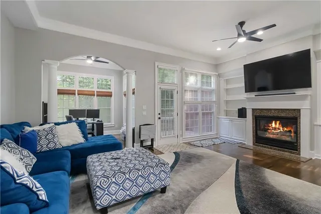 a living room with furniture a flat screen tv and a fireplace