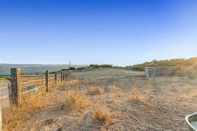 a view of a house with backyard and a tree