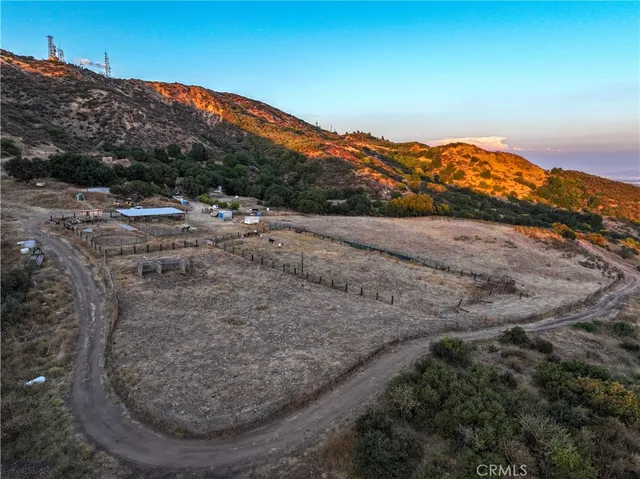a view of a field with trees in the background