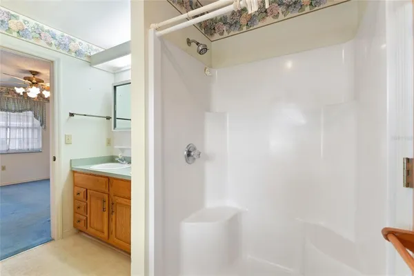 a bathroom with a shower and a sink