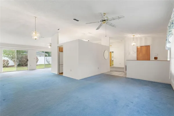 a view of a livingroom with a ceiling fan and window