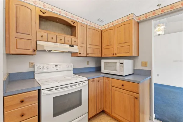 a kitchen with stainless steel appliances granite countertop a sink a stove and cabinets