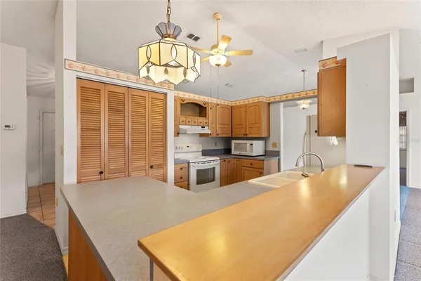 a kitchen with stainless steel appliances granite countertop a sink a stove and cabinets