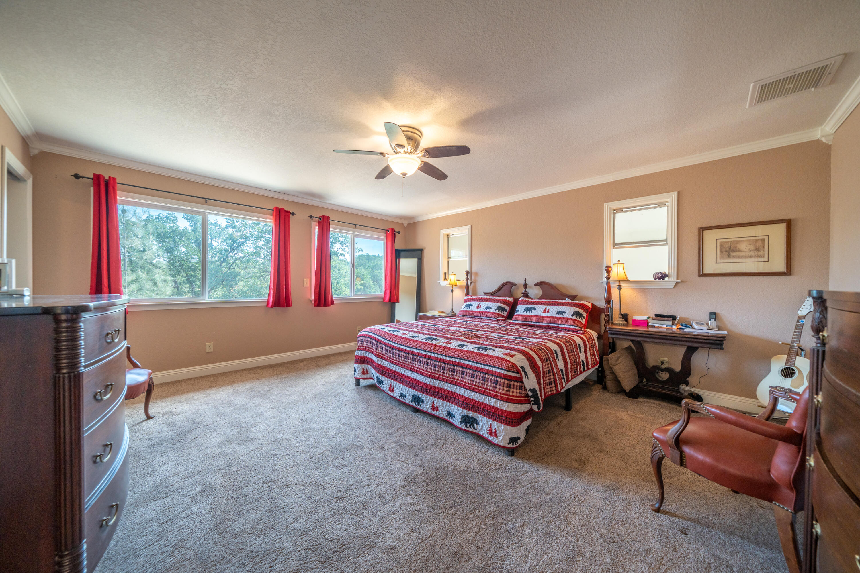 15842 Macleod Drive Redding, CA 96001 - Photo 19 of 36 a spacious bedroom with a bed and a chandelier