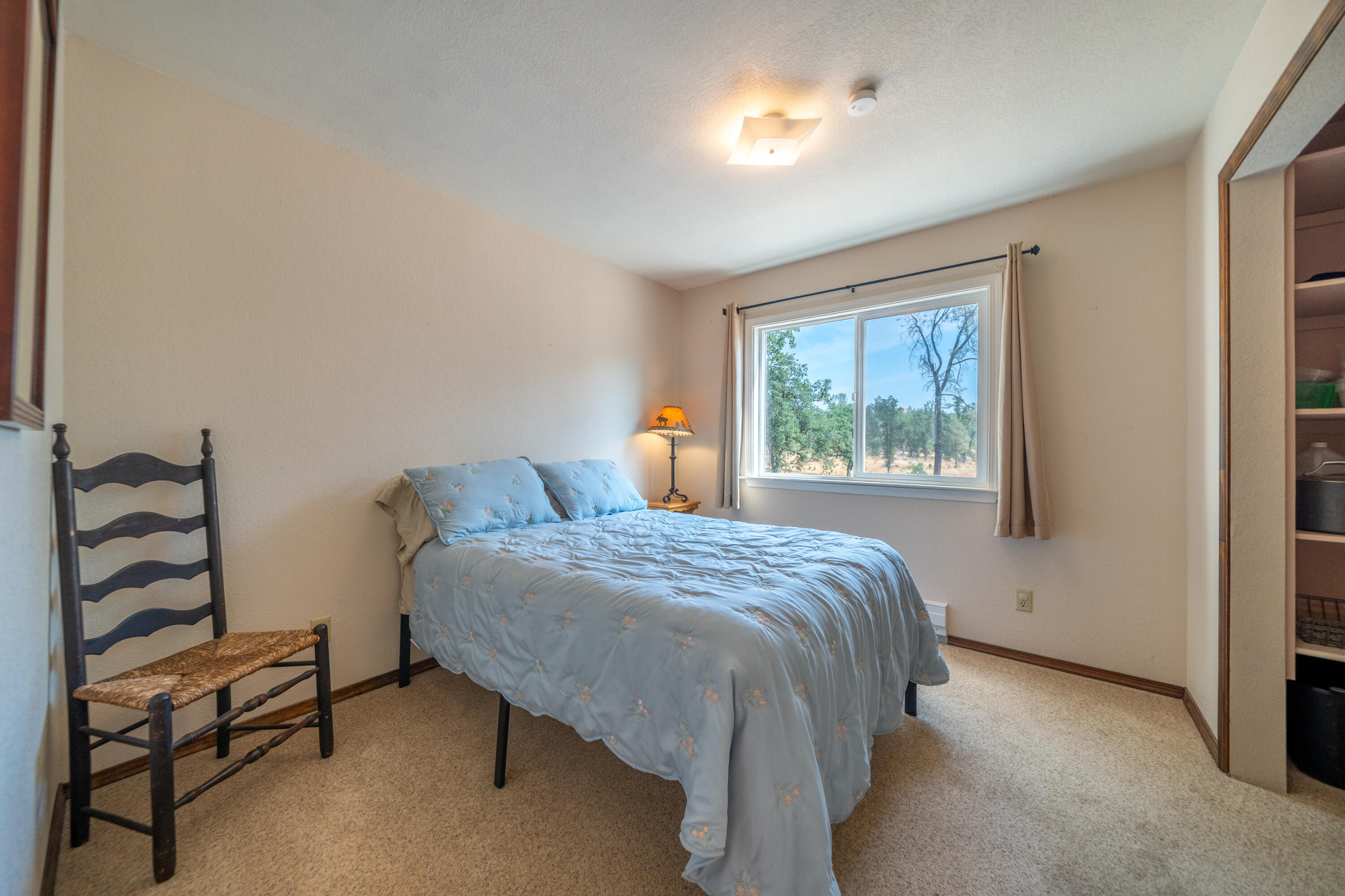 15842 Macleod Drive Redding, CA 96001 - Photo 21 of 36 a bedroom with a bed and a window