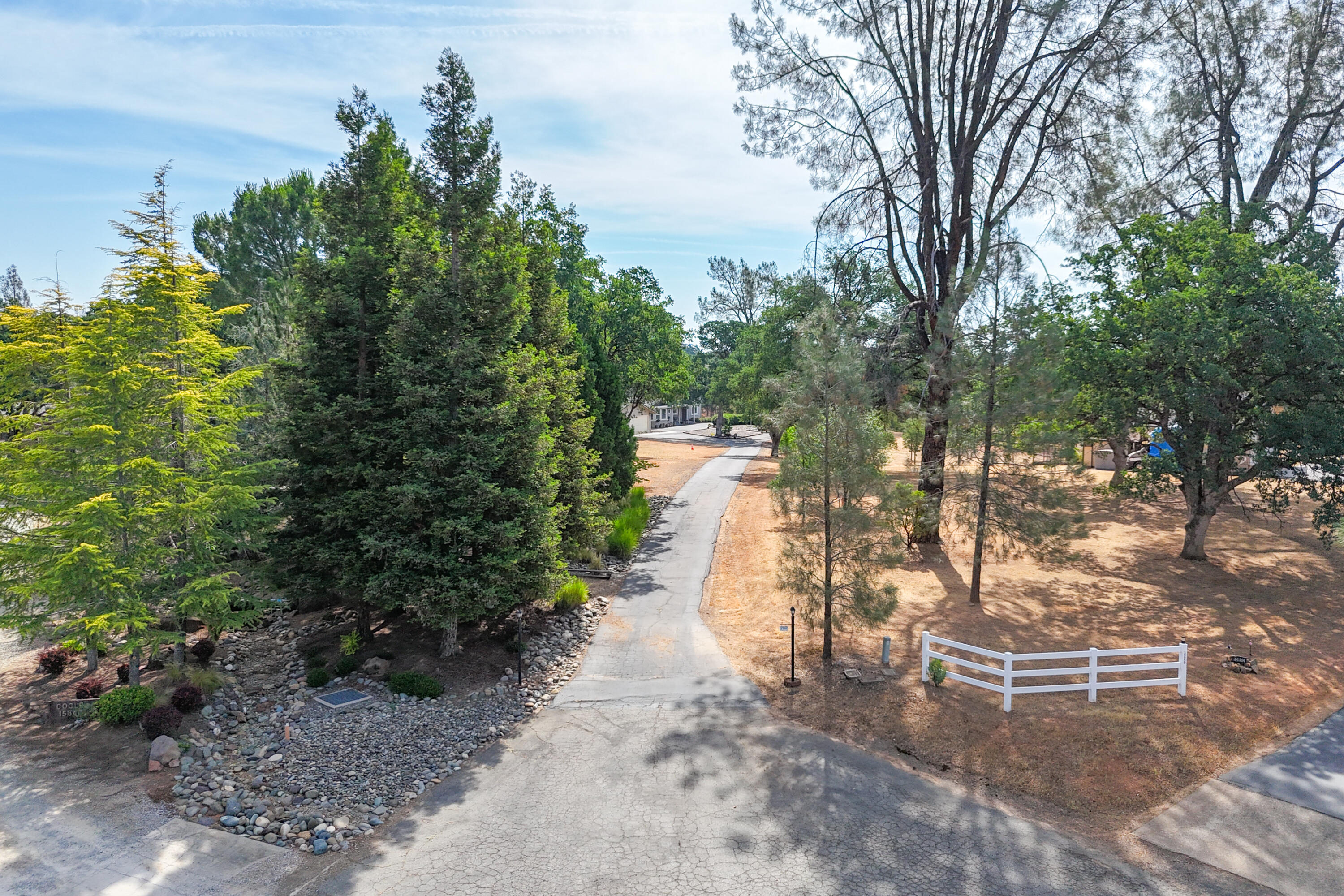 15842 Macleod Drive Redding, CA 96001 - Photo 33 of 36 a view of a pathway with a wrought fence