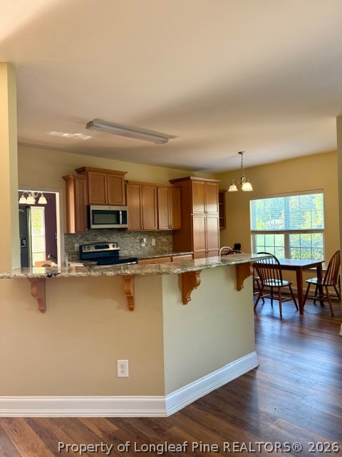 1284 L Cooper Road Cameron, NC 28326 - Photo 5 of 24 a view of a kitchen with kitchen island granite countertop a stove top oven a sink a dining table and chairs with wooden floor