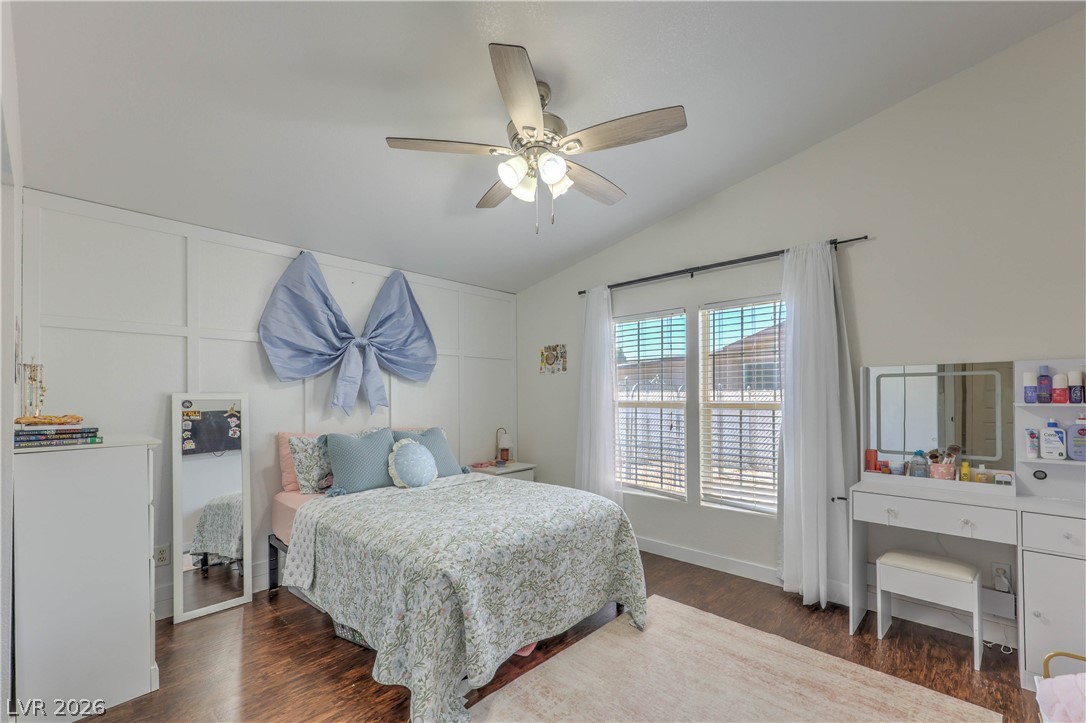 348 Tres Palomas Street Overton, NV 89040 - Photo 25 of 41 A well-lit bedroom with vaulted ceilings, featuring rich hardwood flooring and generous natural illumination.