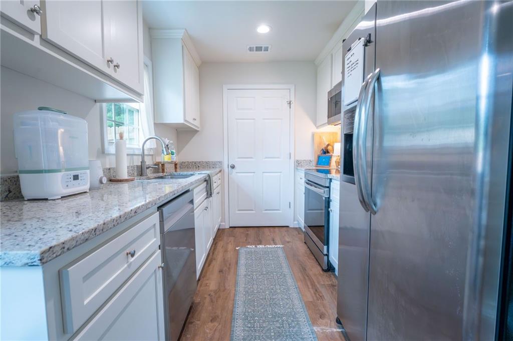 118 Wash Rider Road Dahlonega, GA 30533 - Photo 17 of 37 a kitchen with cabinets and stainless steel appliances