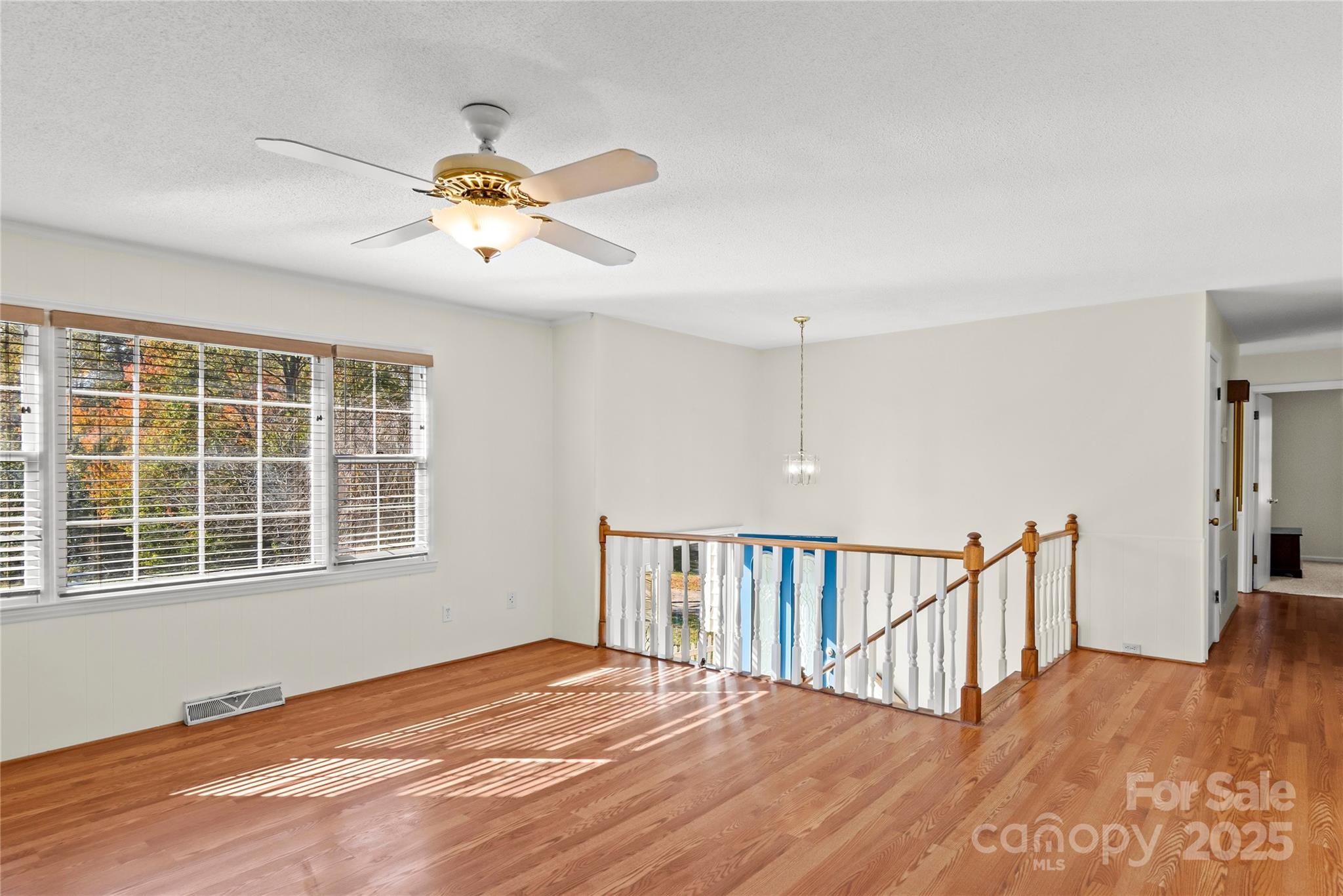 1180 Faulkenberry Road King, NC 27021 - Photo 11 of 40 a view of empty room with wooden floor and fan
