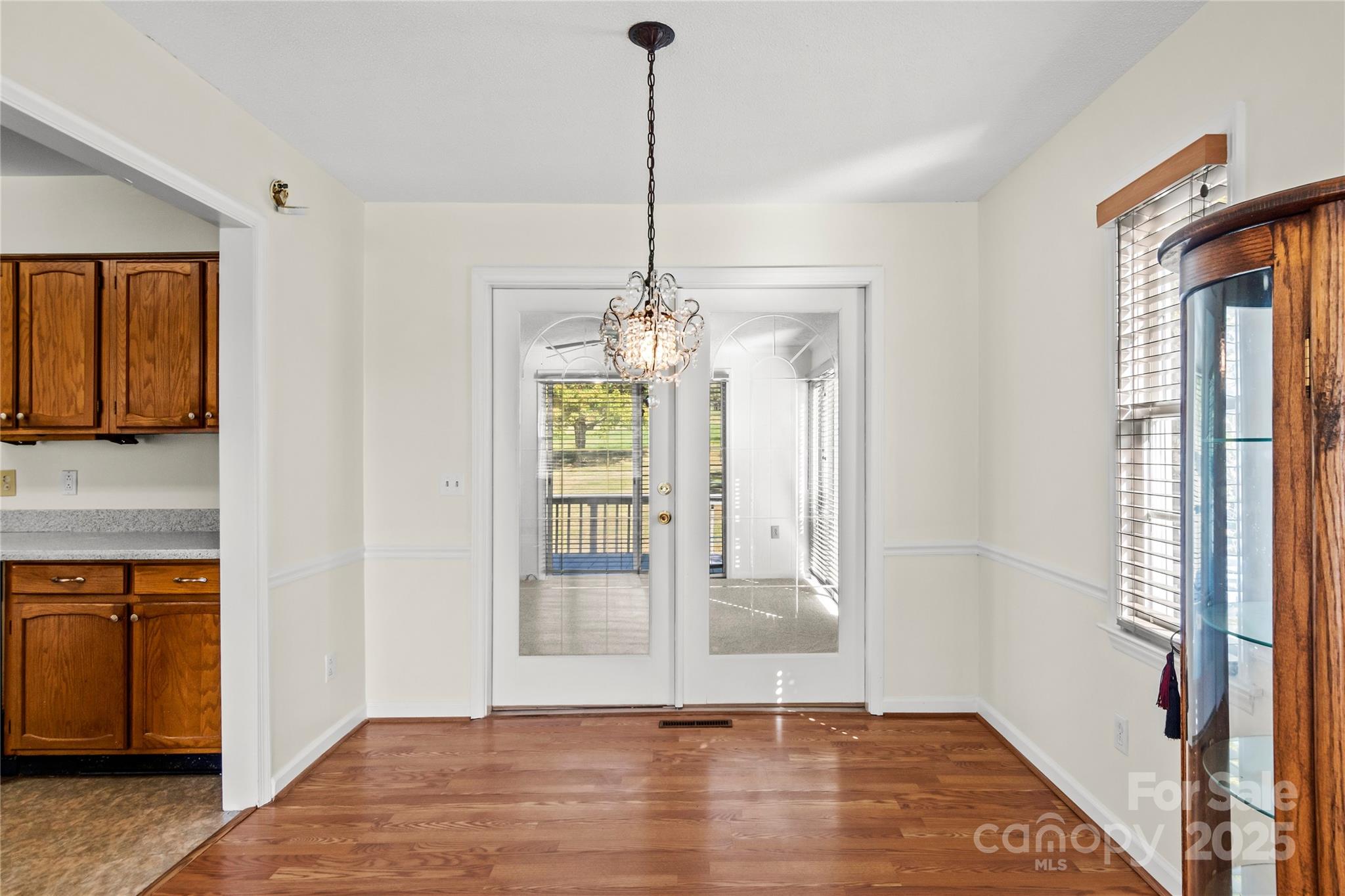 1180 Faulkenberry Road King, NC 27021 - Photo 12 of 40 a view of empty room with wooden floor and fan