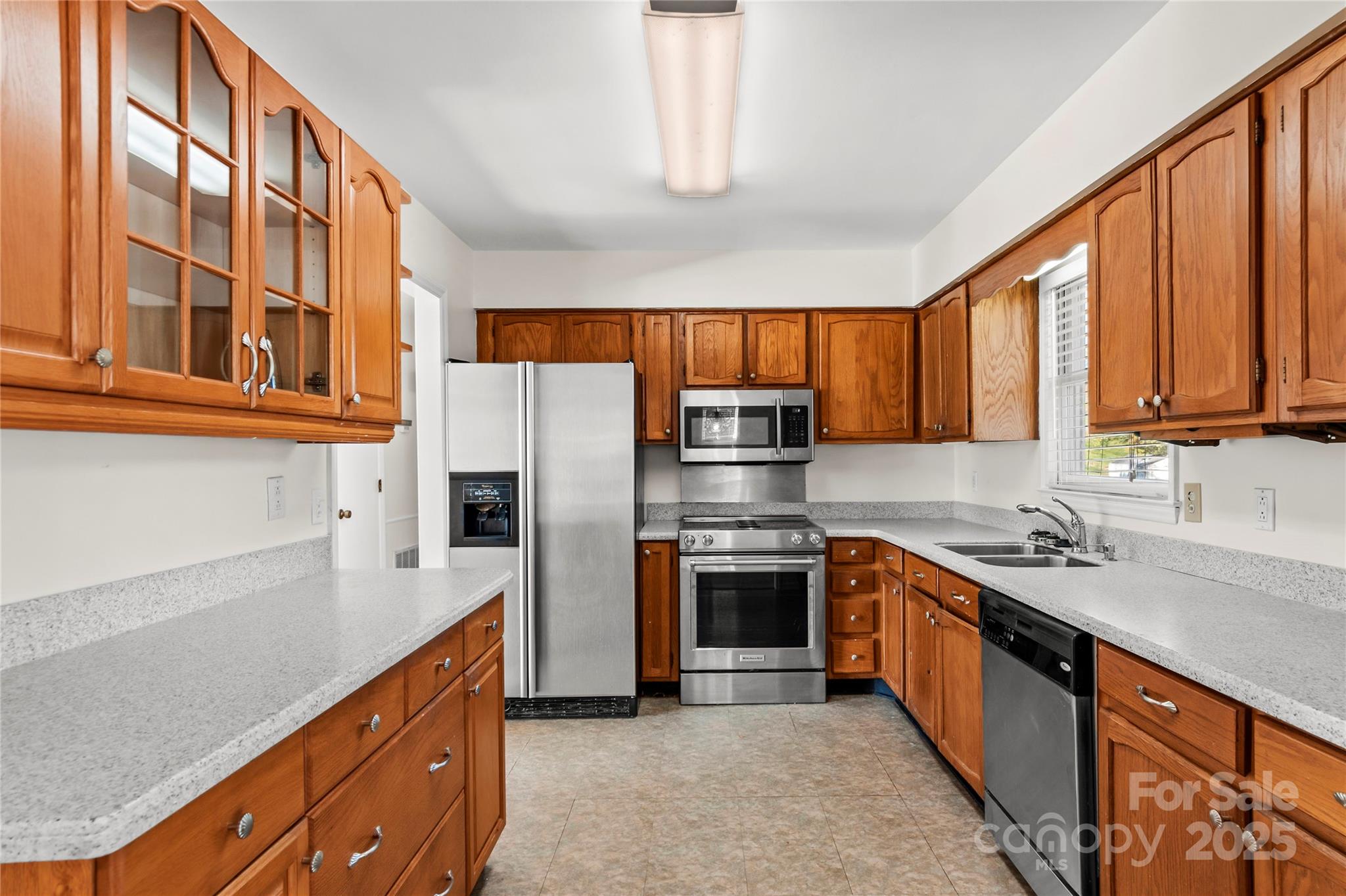 1180 Faulkenberry Road King, NC 27021 - Photo 14 of 40 a kitchen with stainless steel appliances granite countertop a sink stove refrigerator and cabinets