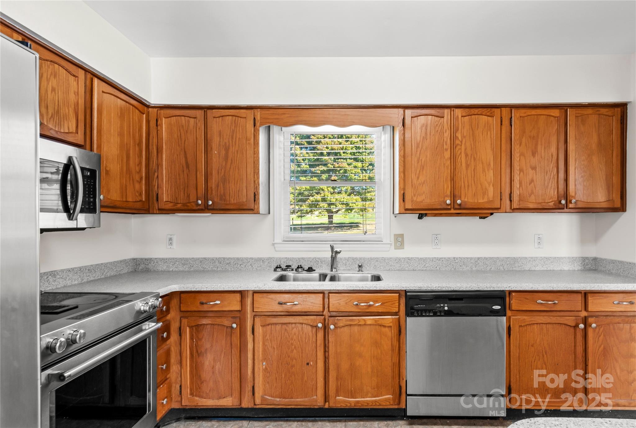 1180 Faulkenberry Road King, NC 27021 - Photo 16 of 40 a kitchen with stainless steel appliances granite countertop a stove a sink and a microwave