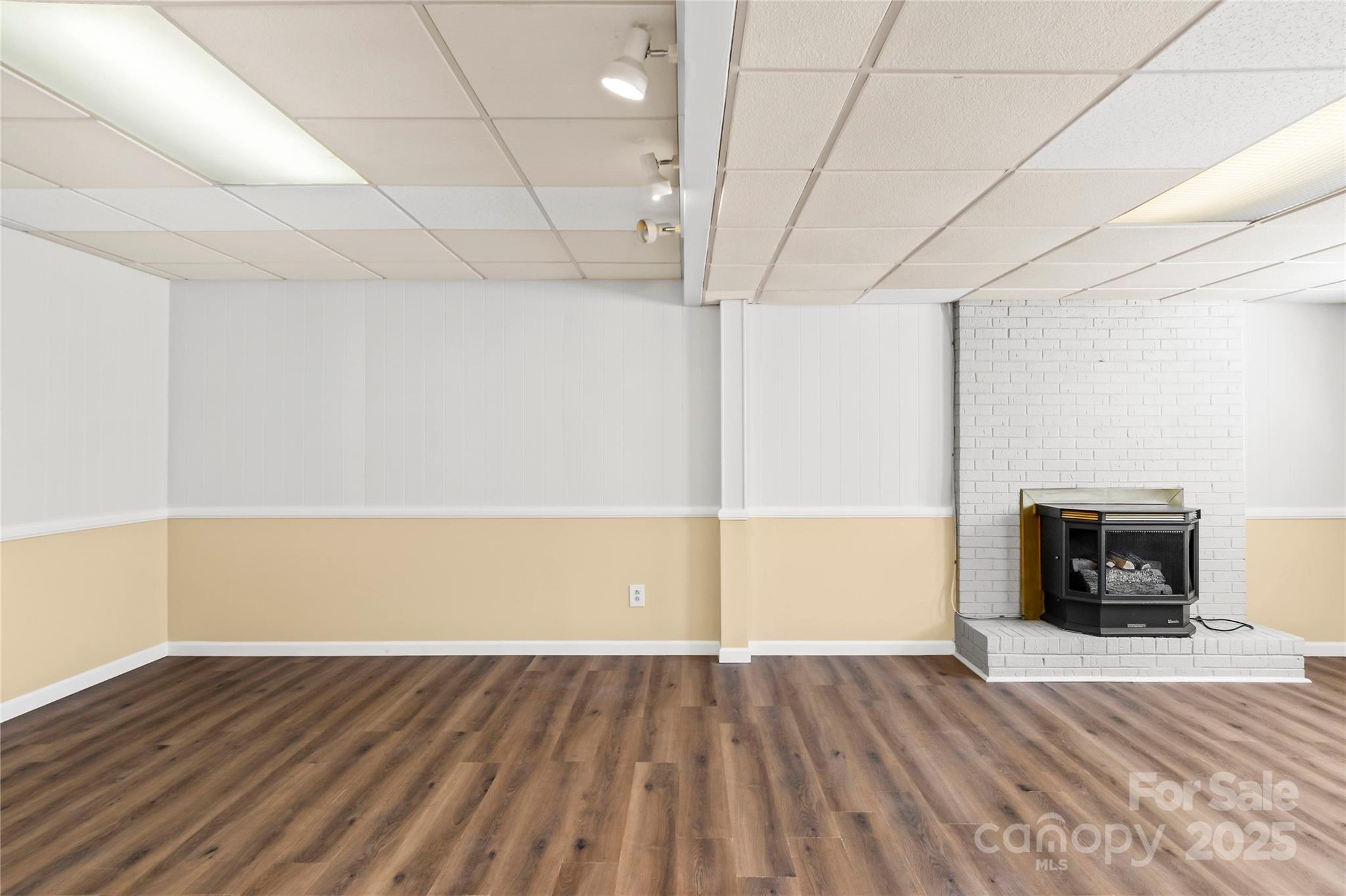 1180 Faulkenberry Road King, NC 27021 - Photo 28 of 40 a view of empty room with wooden floor and fireplace
