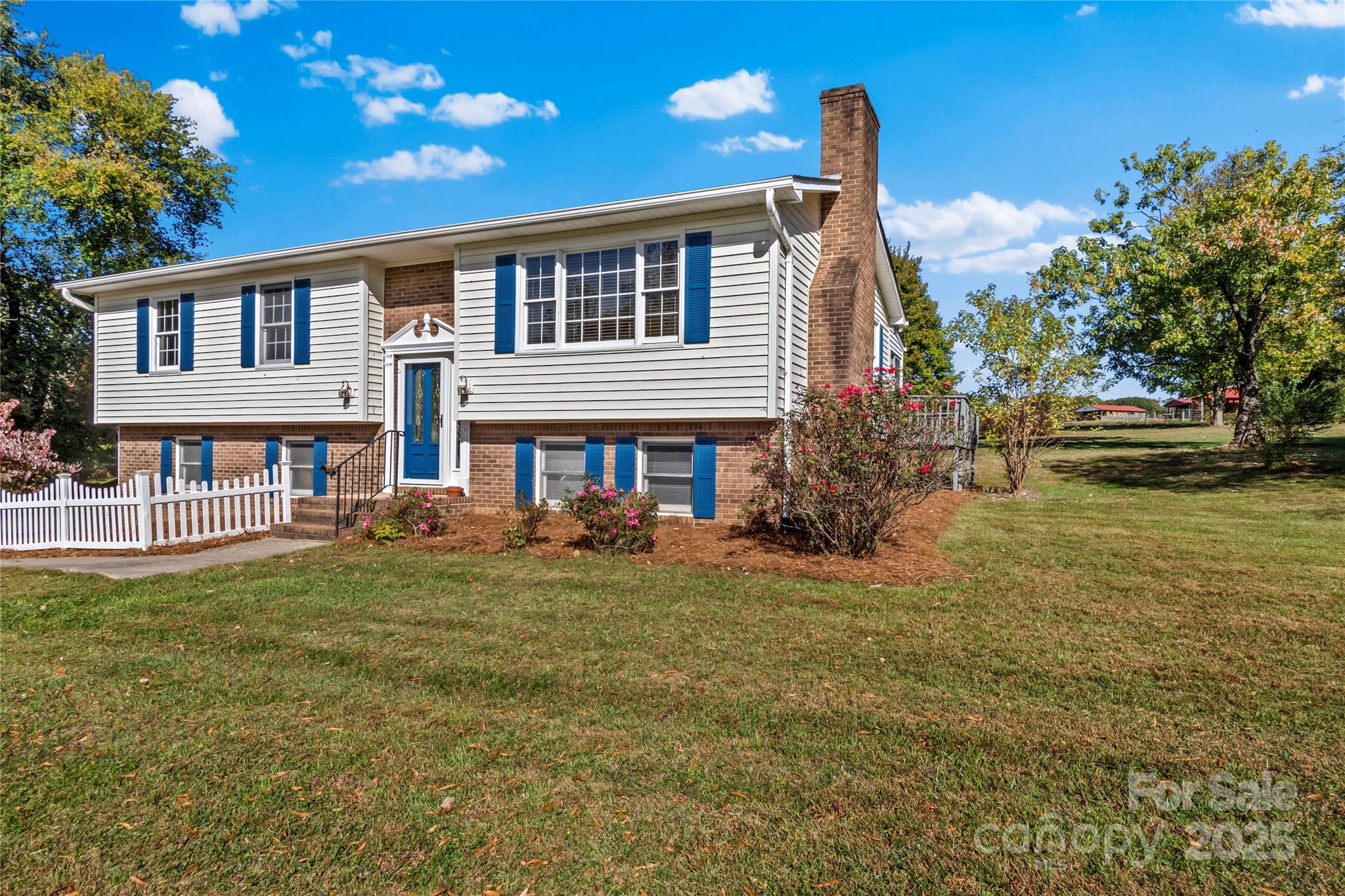 1180 Faulkenberry Road King, NC 27021 - Photo 3 of 40 a front view of a house with a garden
