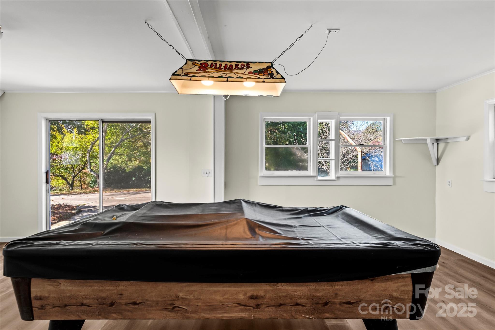 1180 Faulkenberry Road King, NC 27021 - Photo 33 of 40 a living room with a bed and a chandelier