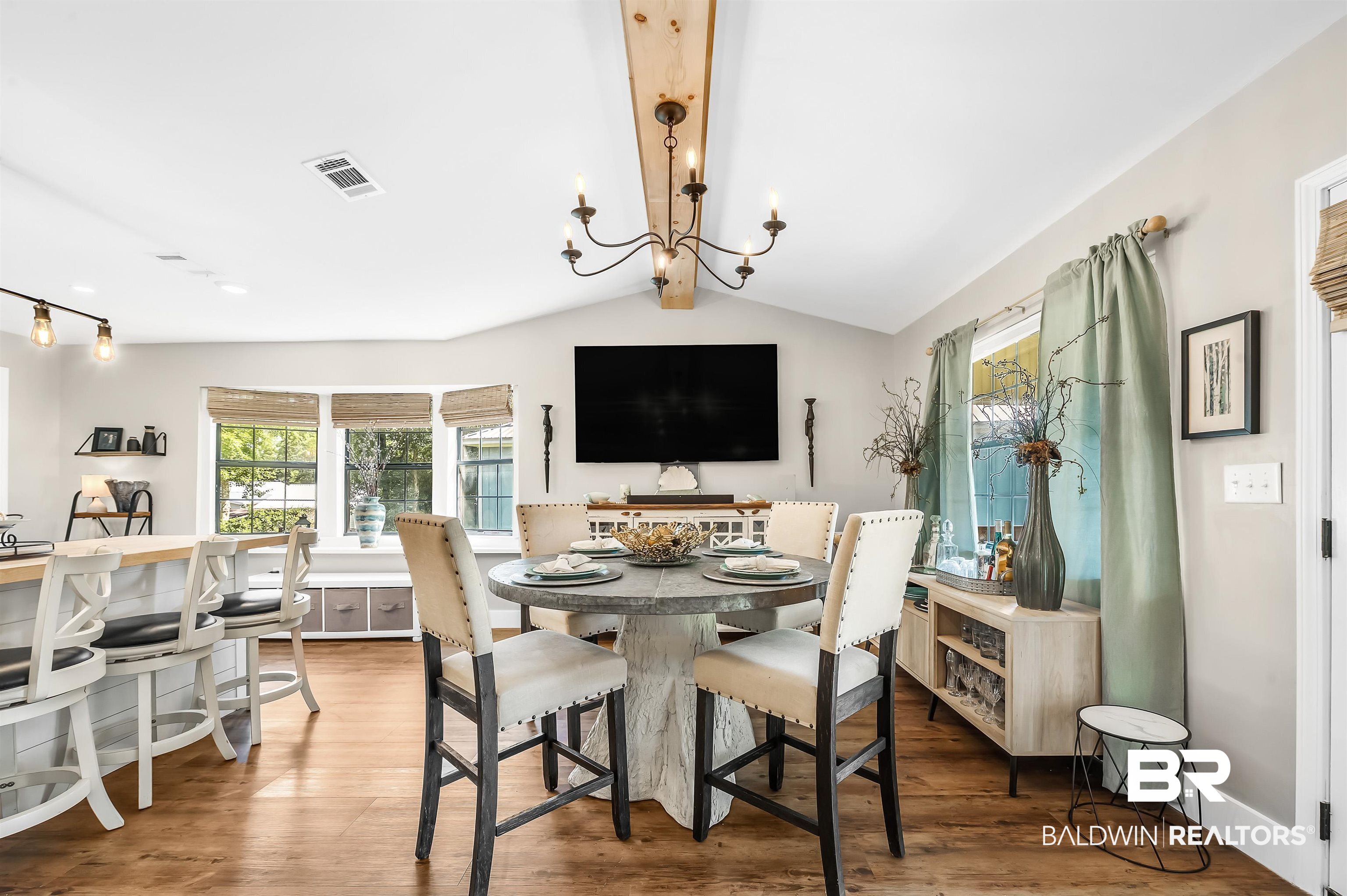 5215 Pine Road Orange Beach, AL 36561 - Photo 18 of 60 Dining space with a chandelier, wood finished floors, and rail lighting