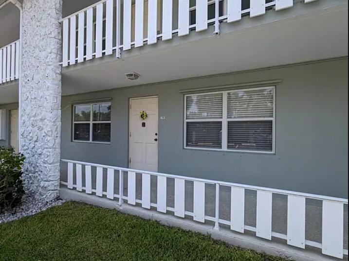 5550 North Ocean Boulevard, Unit 106 Ocean Ridge, FL 33435 - Photo 1 of 15 a view of a house with a backyard porch