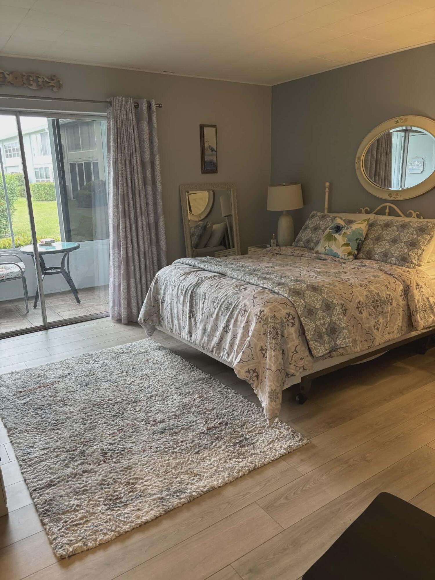 5550 North Ocean Boulevard, Unit 106 Ocean Ridge, FL 33435 - Photo 7 of 15 a bedroom with a bed and large windows