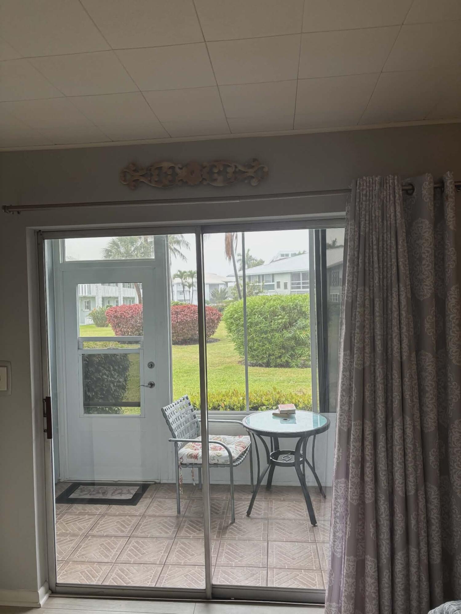 5550 North Ocean Boulevard, Unit 106 Ocean Ridge, FL 33435 - Photo 9 of 15 a view of a room with a table and chairs