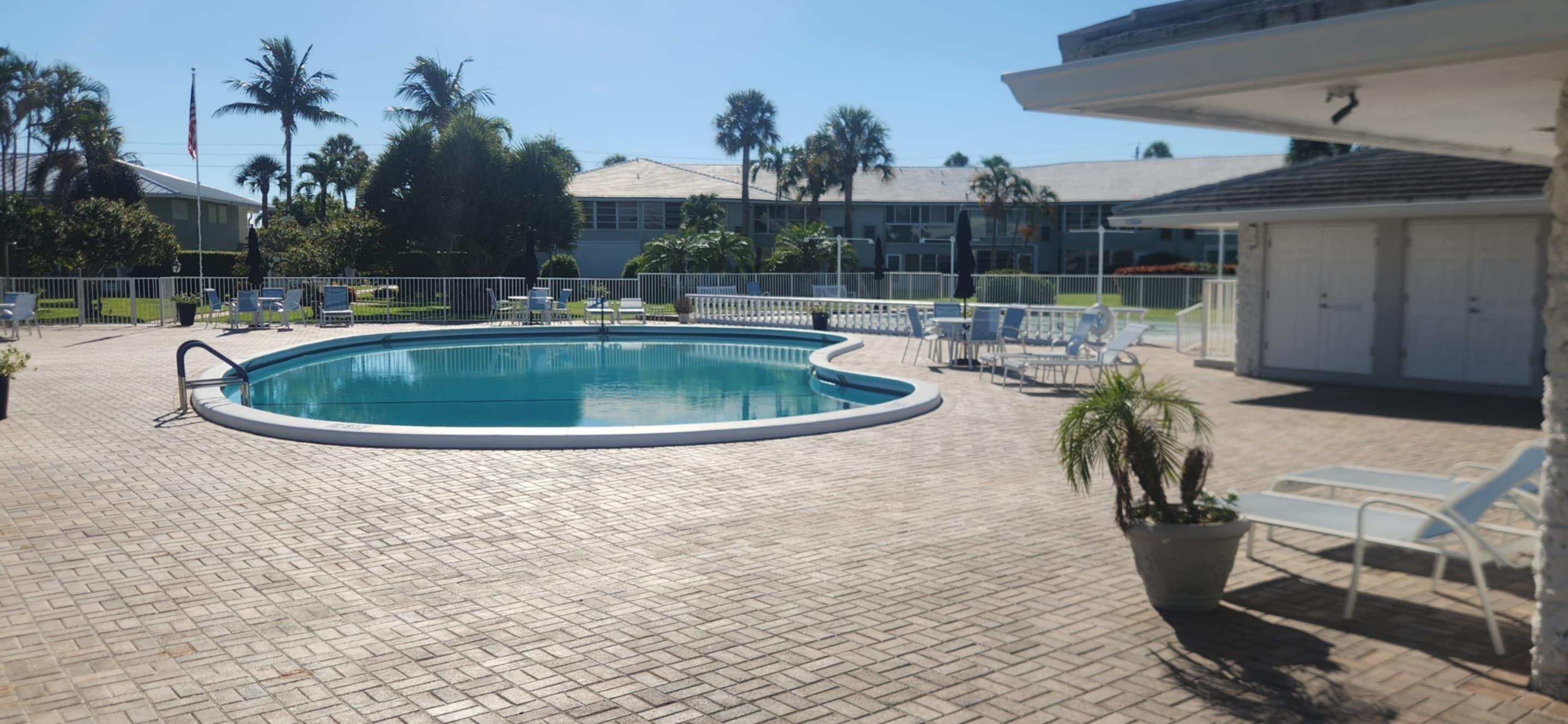 5550 North Ocean Boulevard, Unit 106 Ocean Ridge, FL 33435 - Photo 10 of 15 a view of a swimming pool with sitting area