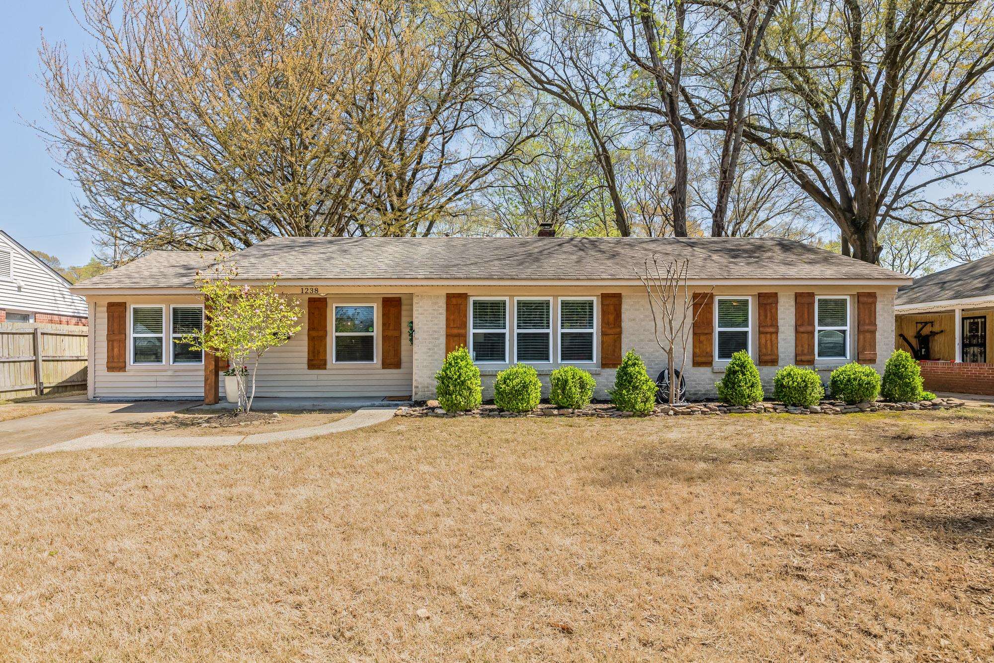 1238 Dearing Road Memphis, TN 38117 - Photo 1 of 24 a front view of a house with a garden and patio