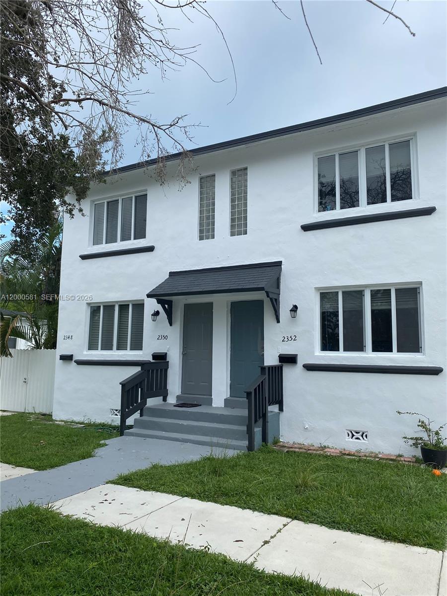2350 Southwest 26th Lane Miami, FL 33133 - Photo 1 of 12 a front view of a house with a yard