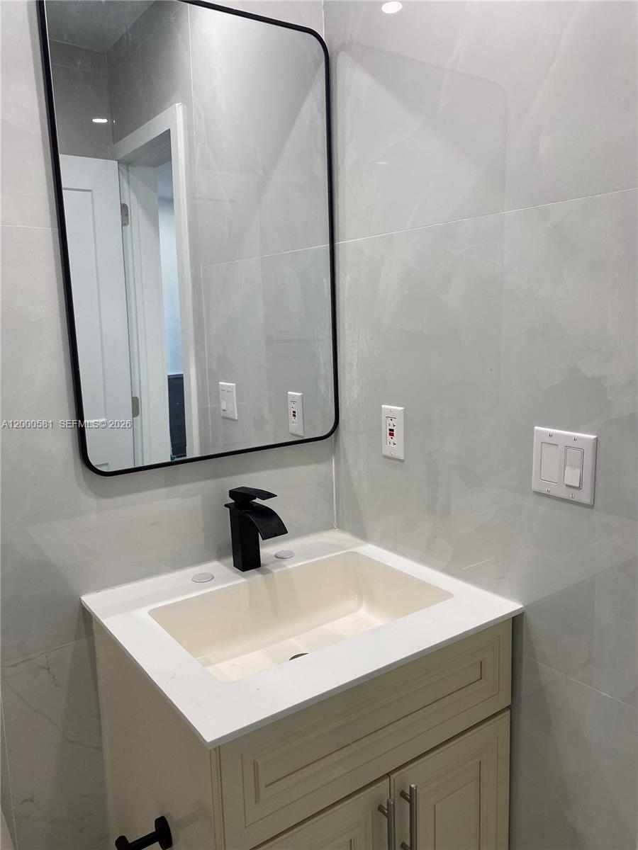 2350 Southwest 26th Lane Miami, FL 33133 - Photo 11 of 12 a bathroom with a sink and a mirror