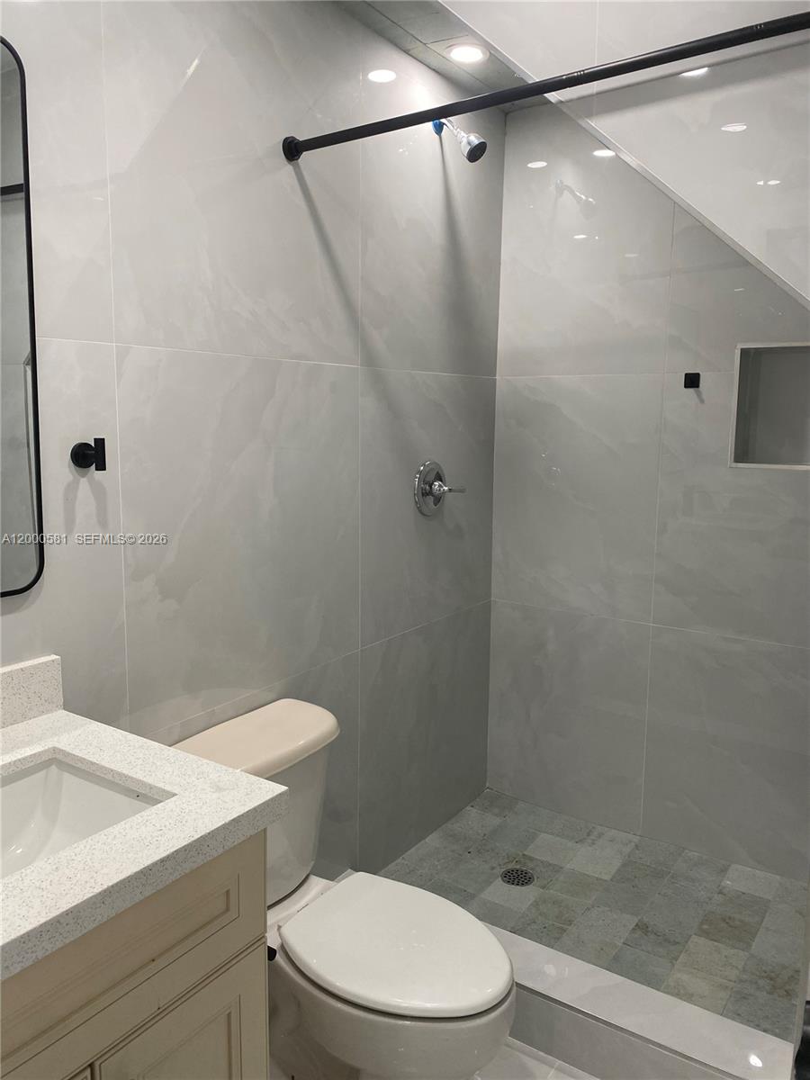 2350 Southwest 26th Lane Miami, FL 33133 - Photo 12 of 12 a white toilet sitting next to a bathroom sink