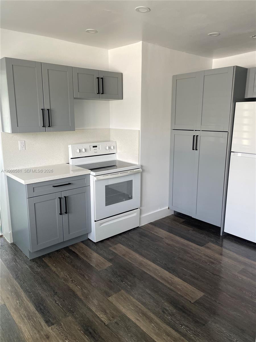 2350 Southwest 26th Lane Miami, FL 33133 - Photo 2 of 12 a kitchen with a sink and a stove top oven