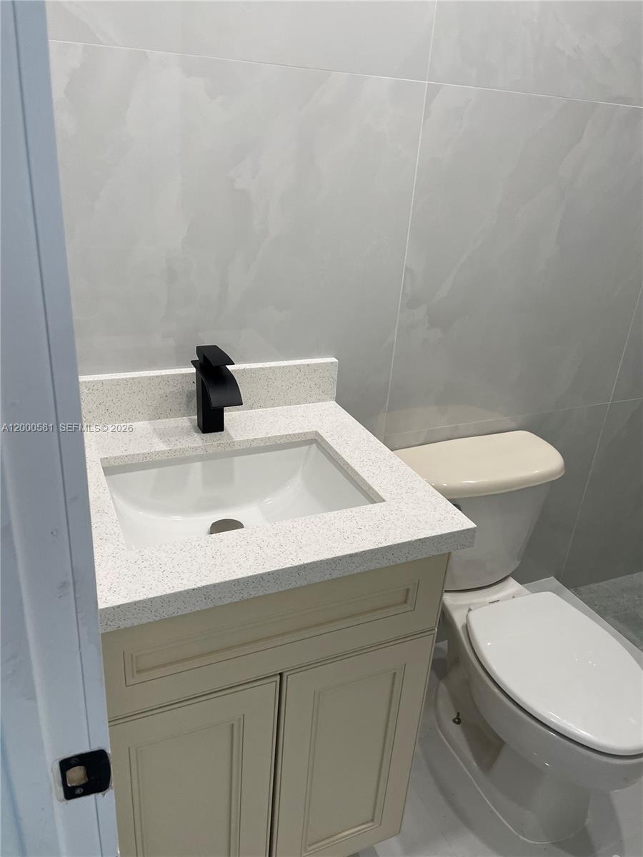2350 Southwest 26th Lane Miami, FL 33133 - Photo 4 of 12 a white toilet sitting next to a white sink