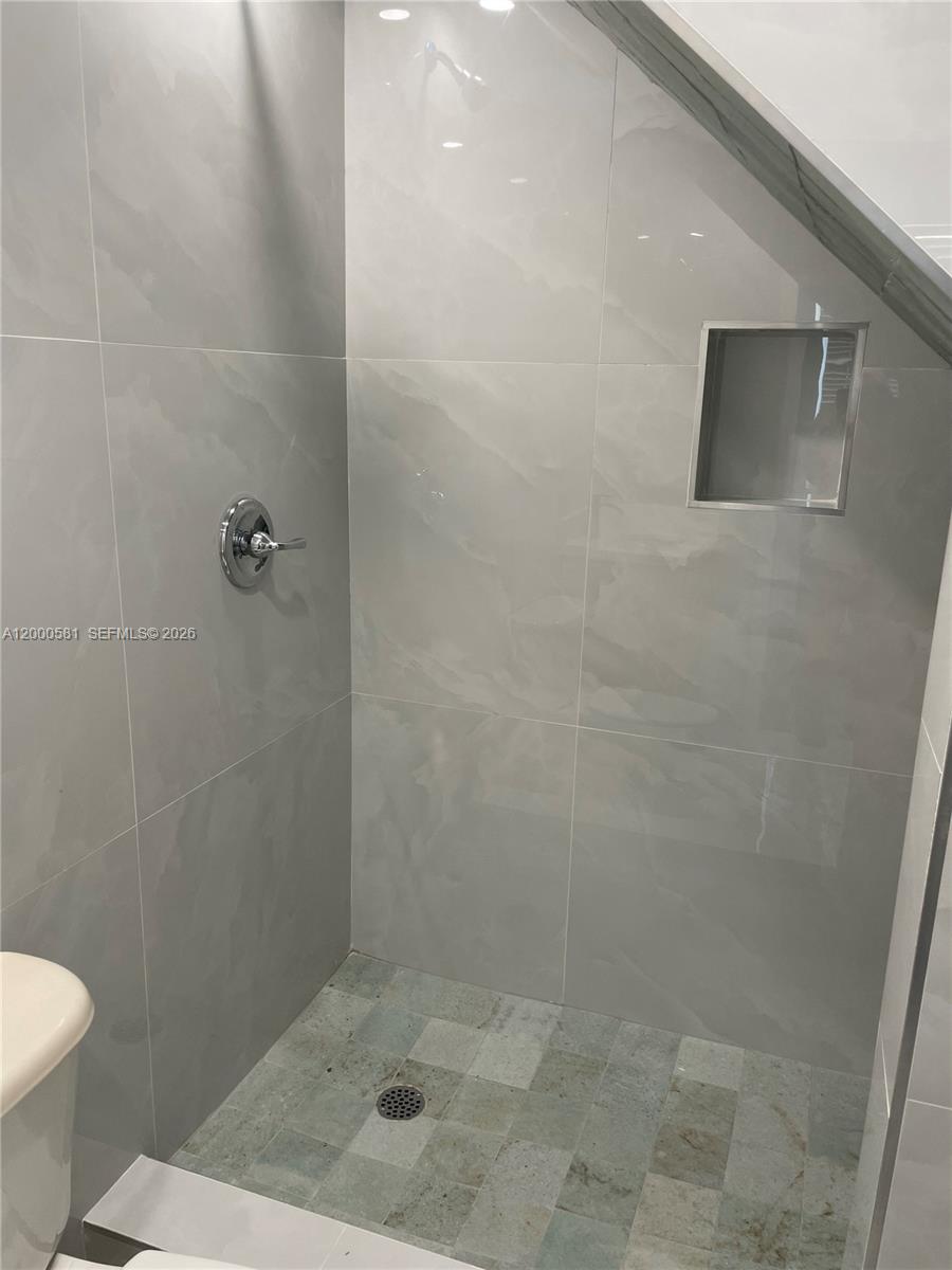 2350 Southwest 26th Lane Miami, FL 33133 - Photo 5 of 12 a bathroom with a shower and toilet