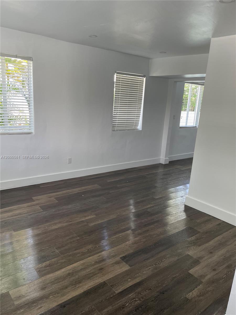 2350 Southwest 26th Lane Miami, FL 33133 - Photo 6 of 12 an empty room with wooden floor and windows