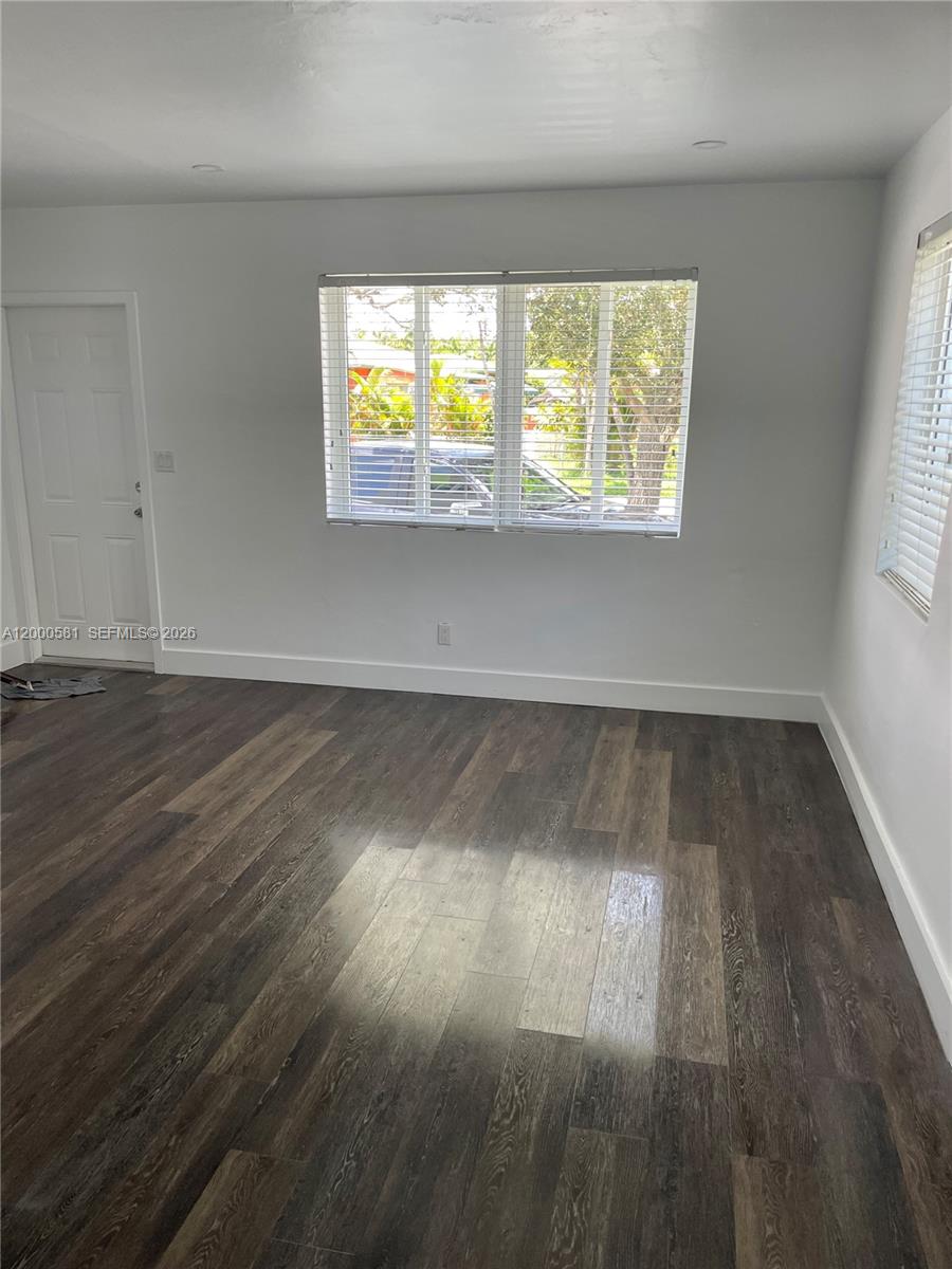 2350 Southwest 26th Lane Miami, FL 33133 - Photo 7 of 12 an empty room with wooden floor and windows