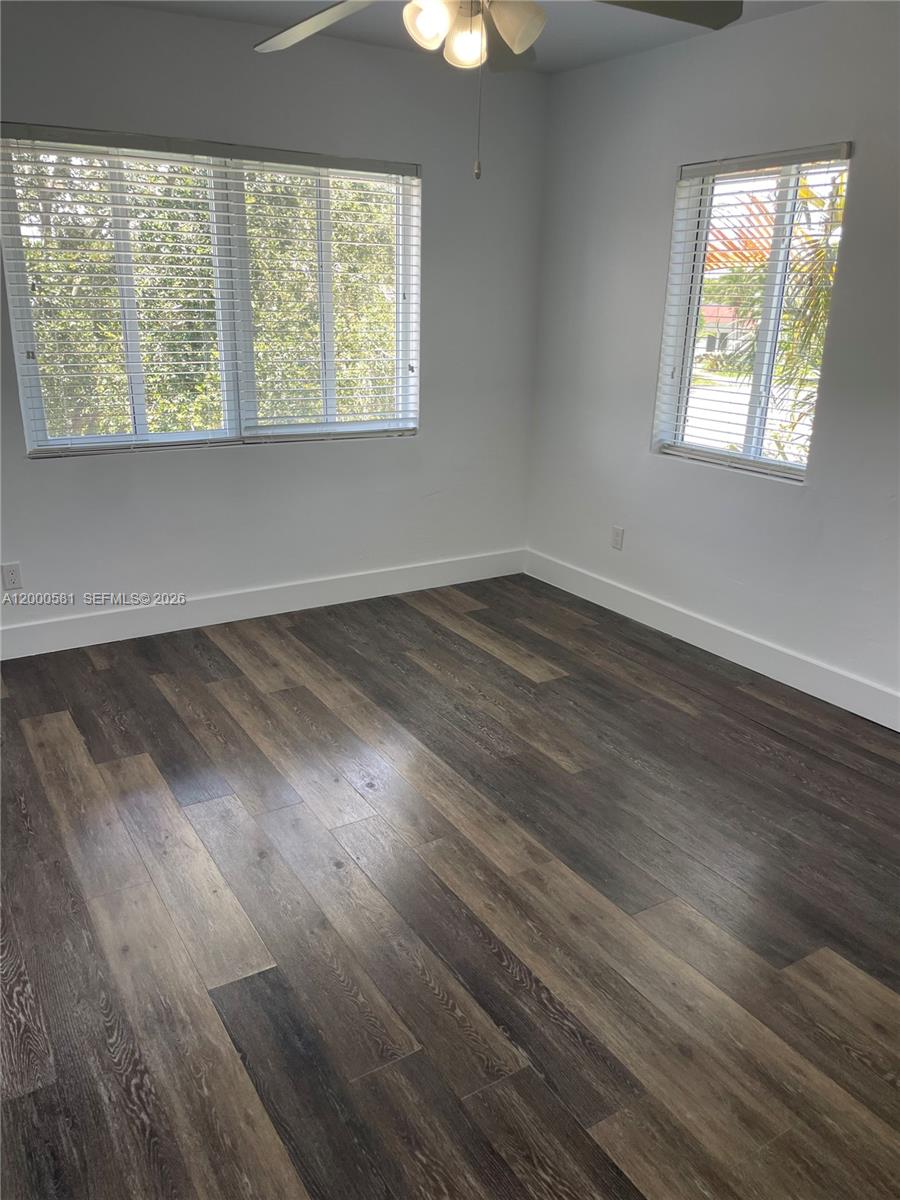 2350 Southwest 26th Lane Miami, FL 33133 - Photo 8 of 12 an empty room with wooden floor and windows