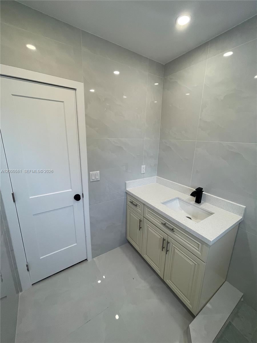 2350 Southwest 26th Lane Miami, FL 33133 - Photo 10 of 12 a bathroom with a sink a toilet and shower