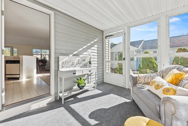 a living room with furniture and a floor to ceiling window