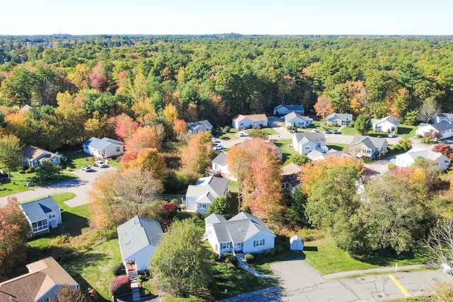an aerial view of a house with a yard