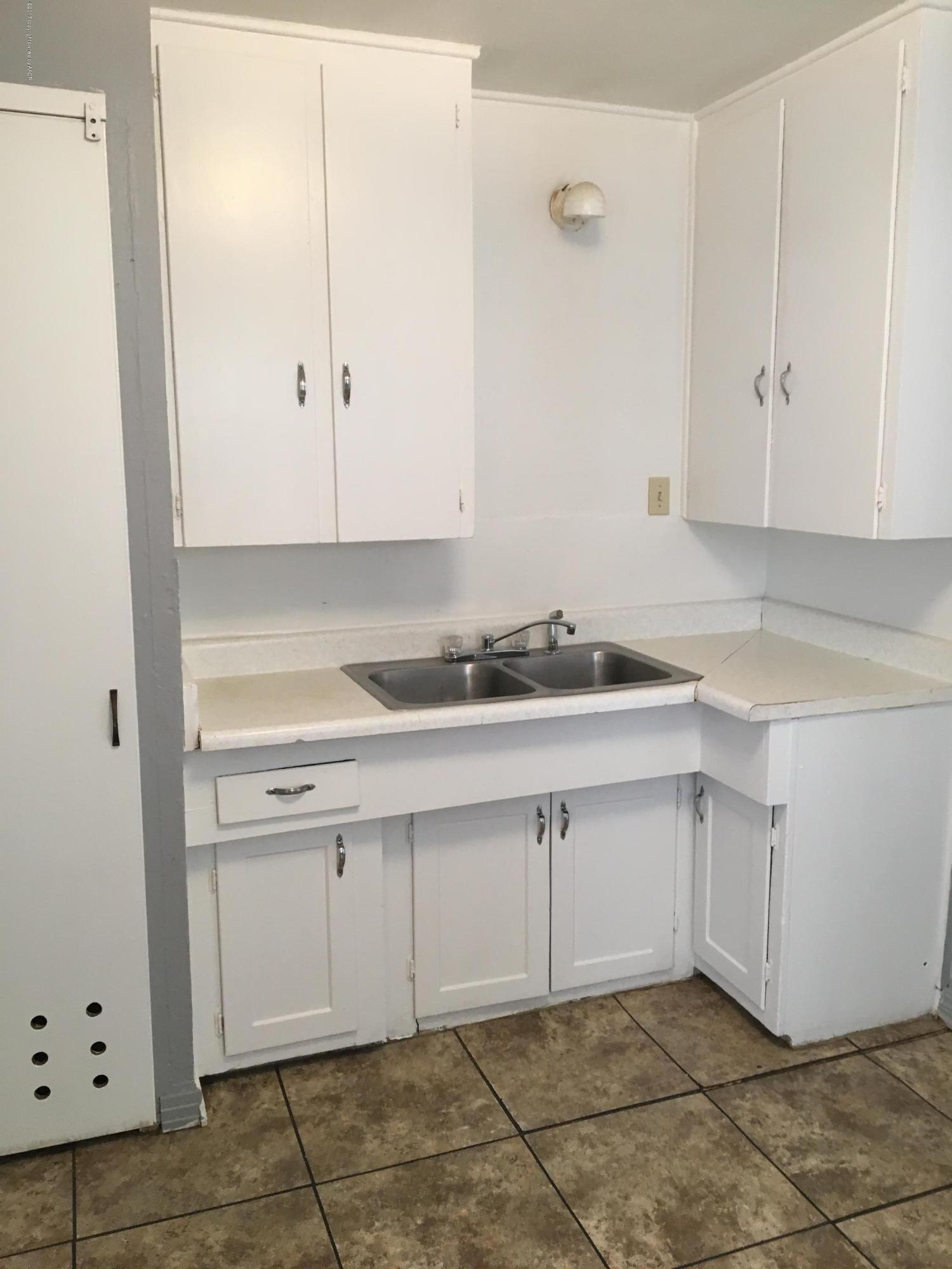4128 South Polk Street Amarillo, TX 79110 - Photo 2 of 10 a kitchen with white cabinets