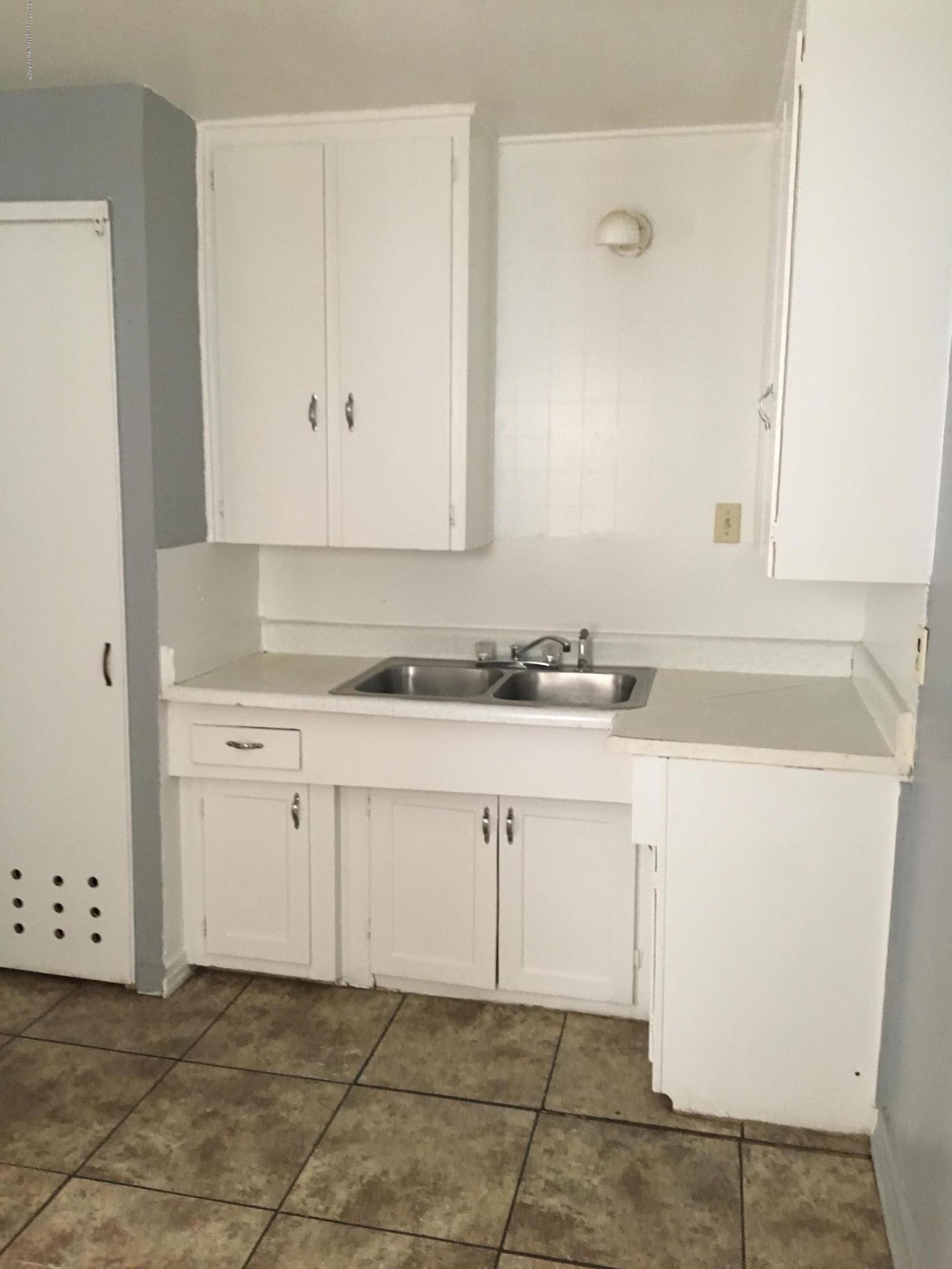 4128 South Polk Street Amarillo, TX 79110 - Photo 3 of 10 a view of cabinets a sink and dishwasher in a white cabinet