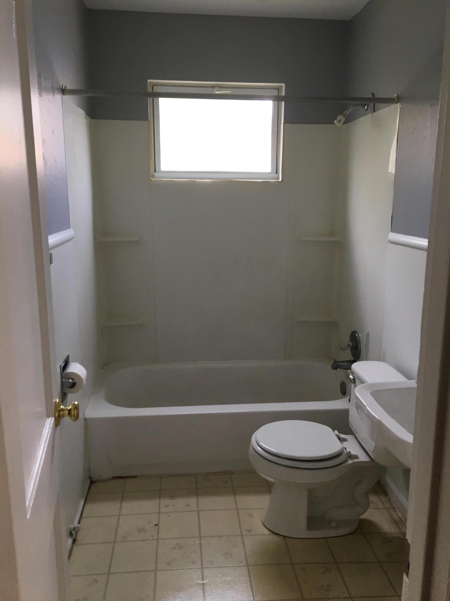 4128 South Polk Street Amarillo, TX 79110 - Photo 6 of 10 a bathroom with a toilet and a bath tub