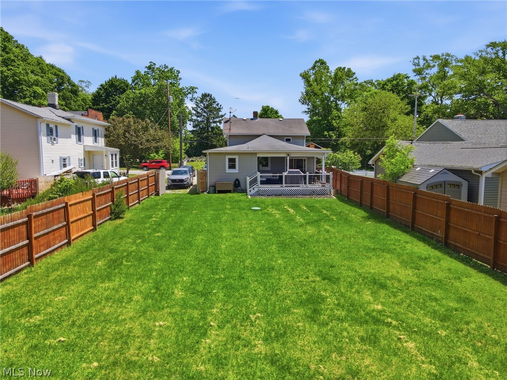 3490 County Line Road Madison, OH 44057 - Photo 15 of 42 Expansive rear yard featuring a large green lawn bordered by a wood privacy fence