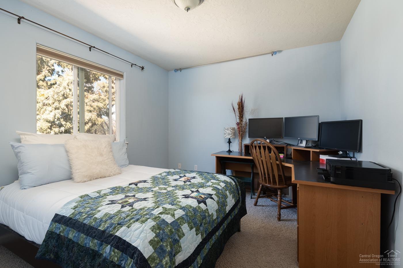 3341 Northeast Stonebrook Loop Bend, OR 97701 - Photo 20 of 25 a bedroom with a bed and a flat screen tv